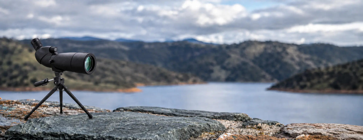 BARSKA Level AD12356 angled spotting scope on tripod at a mountain lake, desktop banner